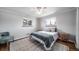 Bright bedroom with a bed, two windows, a ceiling fan, hardwood floors, and neutral décor at 7160 Canosa Ct, Westminster, CO 80030
