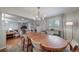 Bright dining room featuring a chandelier, hardwood floors, and access to the living room at 7160 Canosa Ct, Westminster, CO 80030