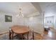 Elegant dining room with an oval table, hardwood floors, and modern chandelier at 7160 Canosa Ct, Westminster, CO 80030