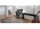 A home office with a desk, monitors, chair, guitar and ample natural light at 7160 Canosa Ct, Westminster, CO 80030