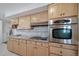 Spacious kitchen with stainless oven and cooktop, tile backsplash, granite counters, and ample wooden cabinetry at 7160 Canosa Ct, Westminster, CO 80030