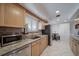 Well-lit kitchen featuring a stainless steel refrigerator, granite countertops, and a cozy breakfast nook at 7160 Canosa Ct, Westminster, CO 80030