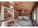 Bright sunroom featuring wood ceilings, brick walls, large windows, and comfortable seating creating a relaxing atmosphere at 7160 Canosa Ct, Westminster, CO 80030