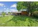 Large, well-maintained backyard with a spacious lawn and a covered patio area at 3625 E 128Th Pl, Thornton, CO 80241