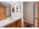 Well-lit bathroom with classic vanity, decorative mirrors, and shower-tub combination at 3625 E 128Th Pl, Thornton, CO 80241