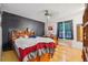 Bright bedroom features wood floors, a ceiling fan, and natural light from the window at 3625 E 128Th Pl, Thornton, CO 80241
