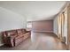 Bright living room featuring hardwood floors, neutral paint, and large windows at 3625 E 128Th Pl, Thornton, CO 80241