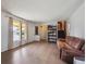 Inviting living room with hardwood floors, large windows, and access to the staircase at 3625 E 128Th Pl, Thornton, CO 80241