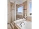 Luxurious bathroom boasts a soaking tub, glass shower, and elegant tile accents at 9084 Ellis Way, Arvada, CO 80005
