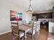 Charming dining area showcases a rustic wood table and seamlessly connects to the kitchen at 9084 Ellis Way, Arvada, CO 80005