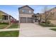 Charming two-story home with a well-manicured lawn and a two car garage at 9084 Ellis Way, Arvada, CO 80005