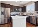 Modern kitchen featuring stainless steel appliances, dark cabinets, and stylish backsplash at 9084 Ellis Way, Arvada, CO 80005