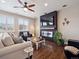 Stylish living room with a modern fireplace, a large flat-screen TV, and comfortable seating at 9084 Ellis Way, Arvada, CO 80005
