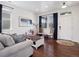 Cozy living room featuring hardwood floors, neutral walls, natural light, and stylish furniture at 9084 Ellis Way, Arvada, CO 80005