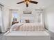Bright main bedroom features soft colors, plush bedding, and abundant natural light at 9084 Ellis Way, Arvada, CO 80005