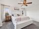 Comfortable main bedroom features an ornate side table, soft bedding, and ample natural light at 9084 Ellis Way, Arvada, CO 80005
