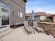 Back patio featuring two lounge chairs, an umbrella and a wall at 9084 Ellis Way, Arvada, CO 80005