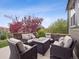 Inviting patio area with stylish outdoor furniture and a cozy fire pit table at 9084 Ellis Way, Arvada, CO 80005