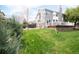 Grassy backyard with a hot tub, deck, and a wooden retaining wall, perfect for outdoor enjoyment at 5962 S Sheridan Way, Littleton, CO 80123