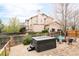 Private backyard with a relaxing hot tub and inviting seating area, set against a backdrop of the home at 5962 S Sheridan Way, Littleton, CO 80123