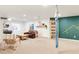 Versatile basement space with aerial yoga setup, lounge area, and entertainment options at 5962 S Sheridan Way, Littleton, CO 80123