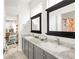 Bathroom with double sinks, large mirrors, and stylish gray cabinetry at 5962 S Sheridan Way, Littleton, CO 80123