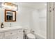 Clean bathroom design with a white vanity, modern lighting, and a shower-tub combination at 5962 S Sheridan Way, Littleton, CO 80123