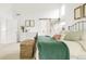 A bright bedroom with a sliding barn door has decoratively framed wall art and light-colored walls at 5962 S Sheridan Way, Littleton, CO 80123
