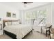 Bright bedroom featuring a large window for natural light and a comfortable bed at 5962 S Sheridan Way, Littleton, CO 80123