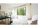 Light and airy bedroom with large windows offering views of lush greenery at 5962 S Sheridan Way, Littleton, CO 80123