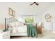 Bright bedroom boasts a wrought iron bed frame, neutral tones, and large windows offering ample natural light at 5962 S Sheridan Way, Littleton, CO 80123