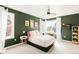 Bedroom with dark green walls, natural light, and modern decor at 5962 S Sheridan Way, Littleton, CO 80123