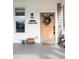 Charming front porch featuring a wooden door adorned with a wreath and decorative welcome accents at 5962 S Sheridan Way, Littleton, CO 80123