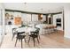 Spacious kitchen with an island, modern cabinetry, and a cozy dining area with seating at 5962 S Sheridan Way, Littleton, CO 80123