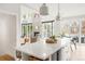 Bright, open kitchen featuring white countertops and modern pendant lighting, seamlessly flowing into the living area at 5962 S Sheridan Way, Littleton, CO 80123