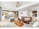 Spacious living room showcases a modern staircase and flows seamlessly into the kitchen at 5962 S Sheridan Way, Littleton, CO 80123