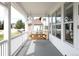 Inviting porch with a charming wooden swing and sun-drenched windows overlooking the neighborhood at 5962 S Sheridan Way, Littleton, CO 80123