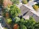 Aerial view of a home surrounded by lush green trees and autumnal foliage at 1355 S Ulster St, Denver, CO 80231