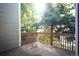 An outdoor wooden deck surrounded by lush greenery providing a private and tranquil space at 1355 S Ulster St, Denver, CO 80231