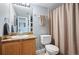 Cozy bathroom featuring a granite countertop, wooden cabinets, and neutral-toned decor at 1355 S Ulster St, Denver, CO 80231