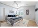 Bright bedroom features a ceiling fan, a large window, and neutral decor for a relaxing ambiance at 1355 S Ulster St, Denver, CO 80231
