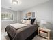 Carpeted bedroom with a large window and two side tables at 1355 S Ulster St, Denver, CO 80231