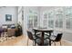 Bright breakfast nook with light hardwood floors, large windows, and sliding glass doors to a private patio at 1355 S Ulster St, Denver, CO 80231