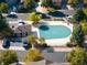 Aerial view of the community pool, pool house, and surrounding trees and parking at 1355 S Ulster St, Denver, CO 80231