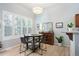Inviting dining area with views of outdoor landscape, adjacent to open living and kitchen spaces at 1355 S Ulster St, Denver, CO 80231