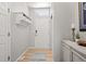 Clean entryway featuring coat hooks, storage shelves, a console table, and neutral-colored walls at 1355 S Ulster St, Denver, CO 80231
