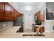 Kitchen features stainless steel appliances, wooden cabinets, light countertops and sink at 1355 S Ulster St, Denver, CO 80231