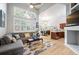 Open-concept living space with vaulted ceilings, large windows, and hardwood floors; a spacious and inviting design at 1355 S Ulster St, Denver, CO 80231
