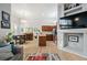 Open living area with eat-in kitchen and dining table with bright light and hardwood floors at 1355 S Ulster St, Denver, CO 80231