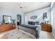 Spacious bedroom boasts a ceiling fan, light-filled windows, and two dressers at 1355 S Ulster St, Denver, CO 80231